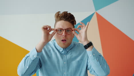 man adjusting glasses