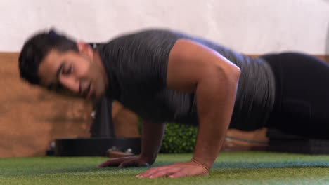 muscular man performing a variation of the classic push-up exercise