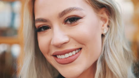 portrait of pretty young blonde woman in makeup with lipstick looking at camera