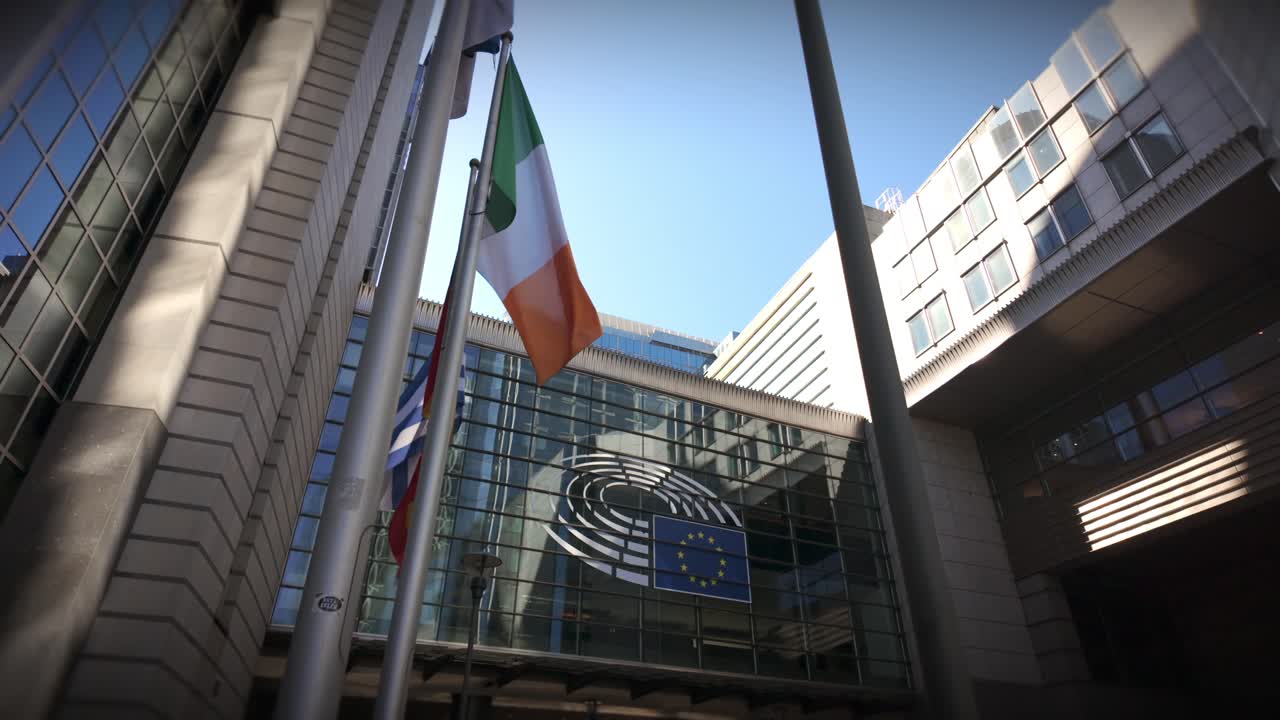 European Parliament building with flags waving in Brussels