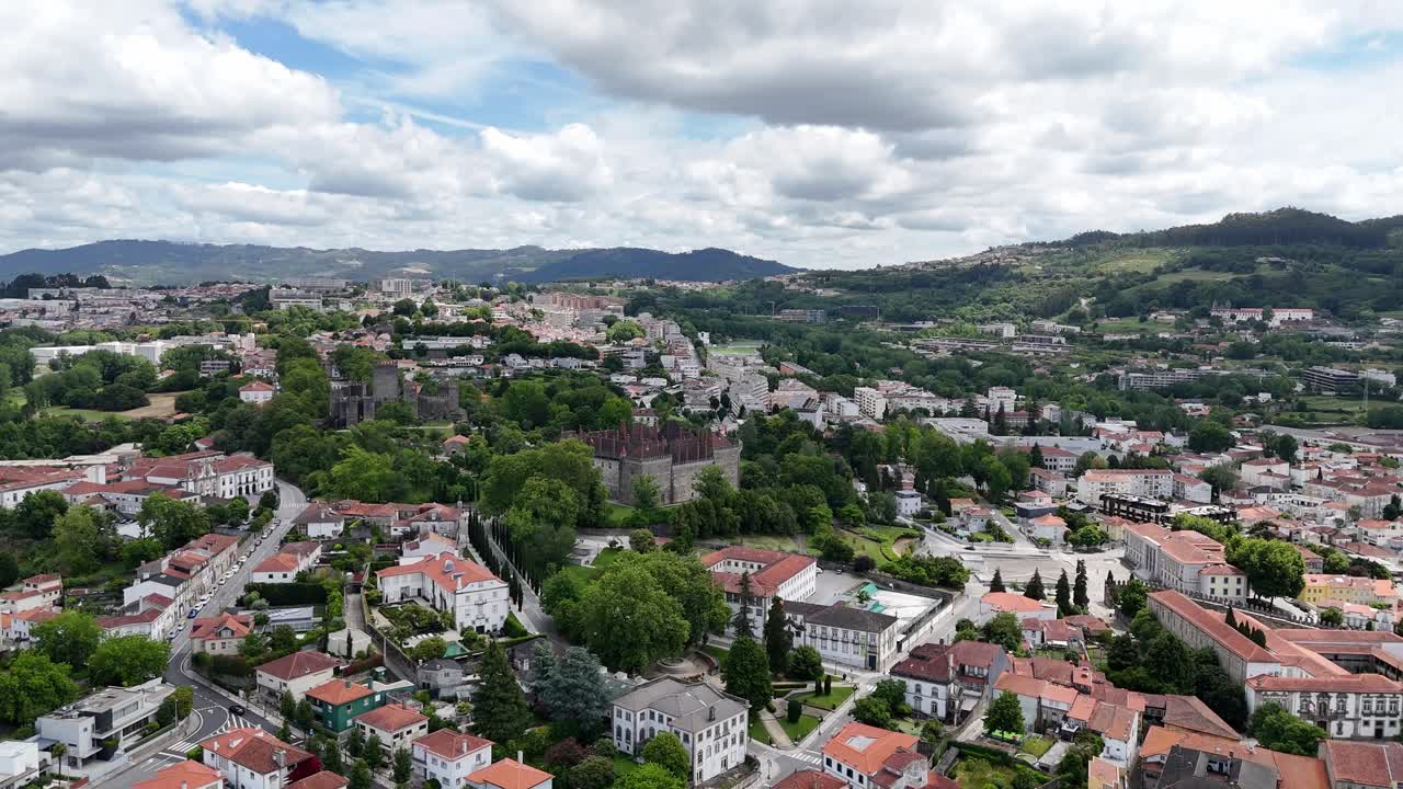 Aerial cityscape of Guimarães with the historic castle and green surroundings in Portugal