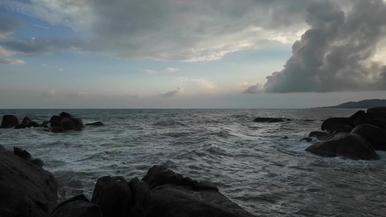 Scenic View of Waves Crashing onto Rocky Beach During Summertime