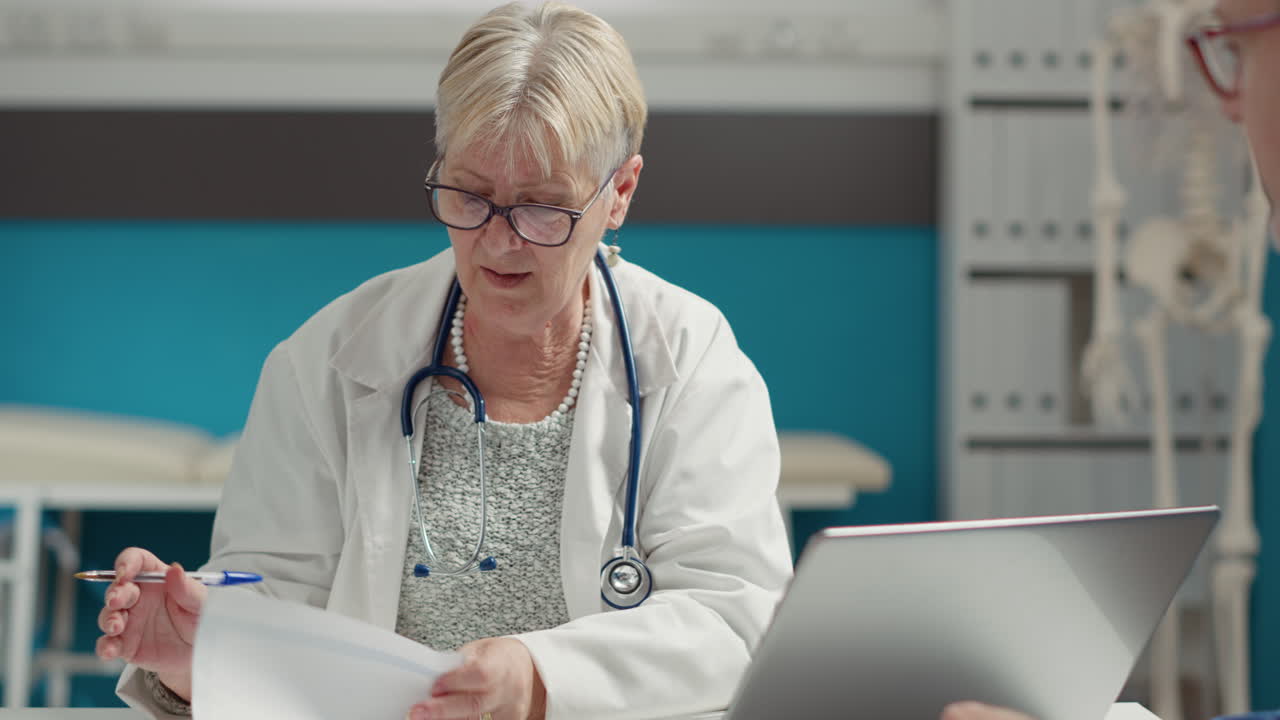 General practitioner taking checkup visit notes on documents