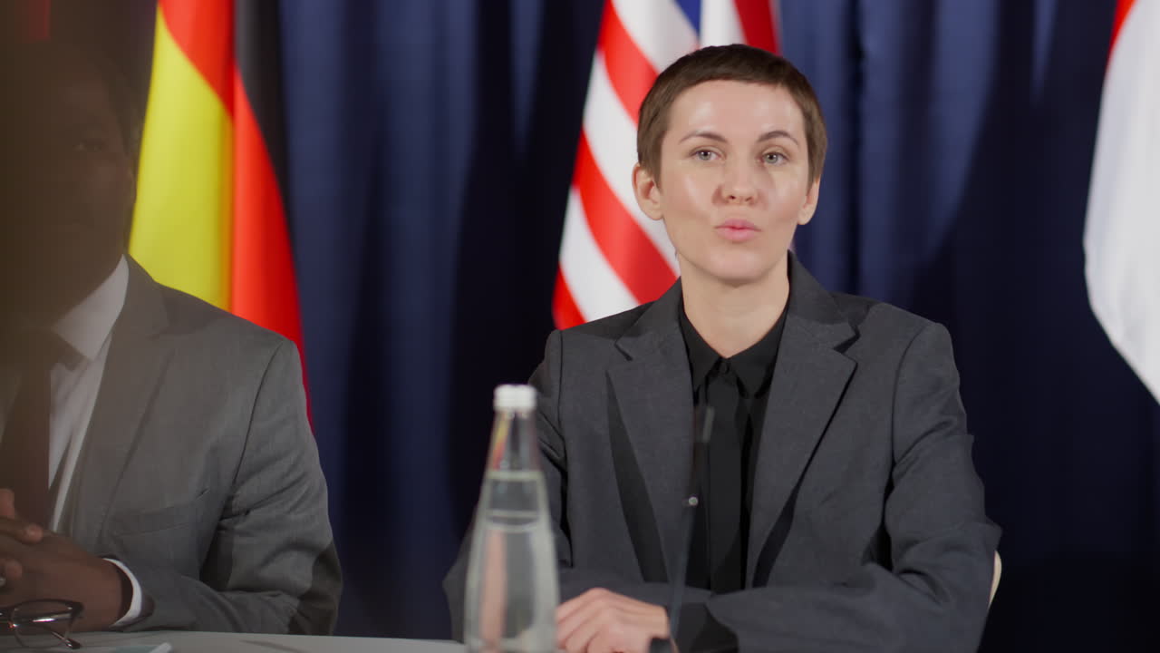 Female Politician Speaking with Journalist at Press Conference