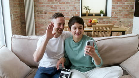 couple doing videocall on the sofa