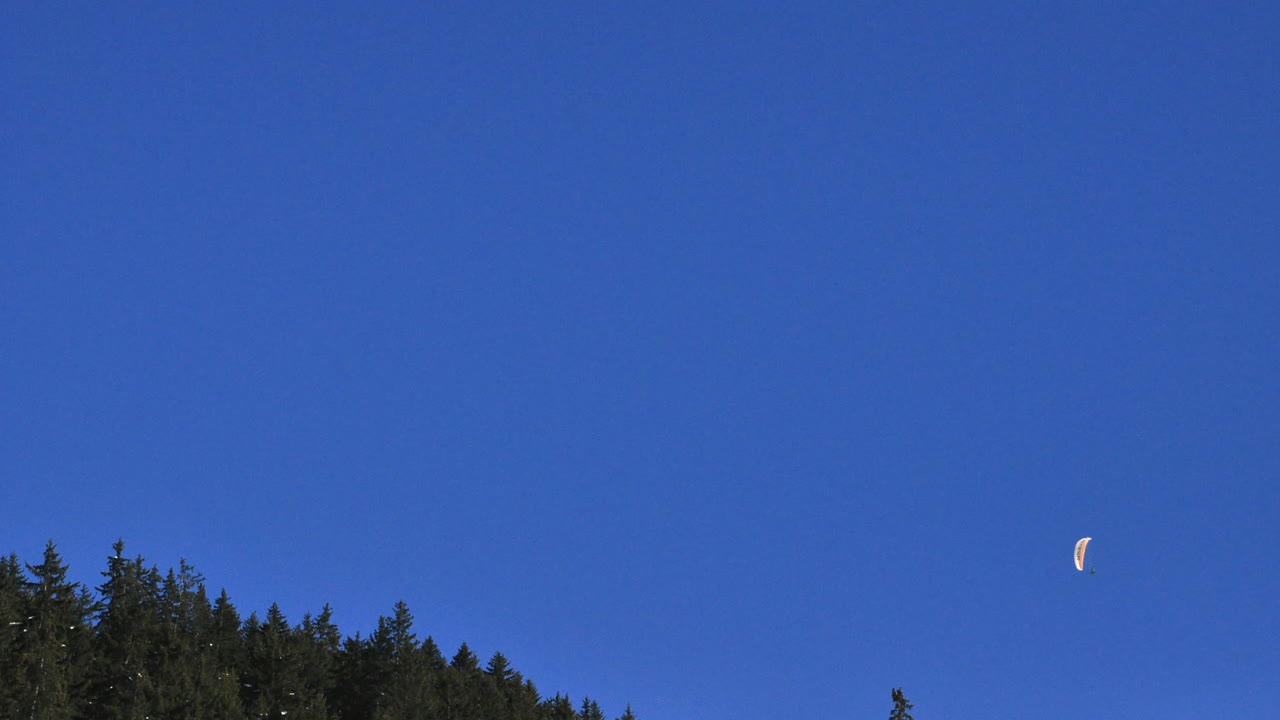 푸른 하늘이 있는 프랑스 알프스에서 패러글라이더의 시간 경과