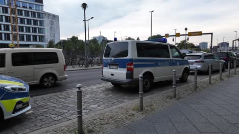 police vehicles lined up along a berlin street. a scene depicting law enforcement presence in the city