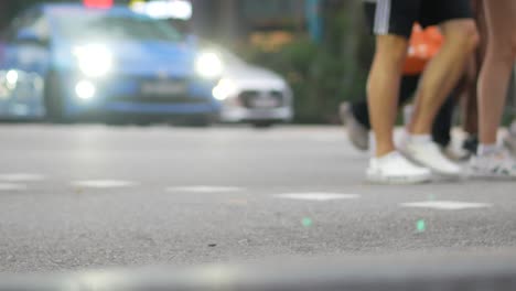 people walking across street at night/day