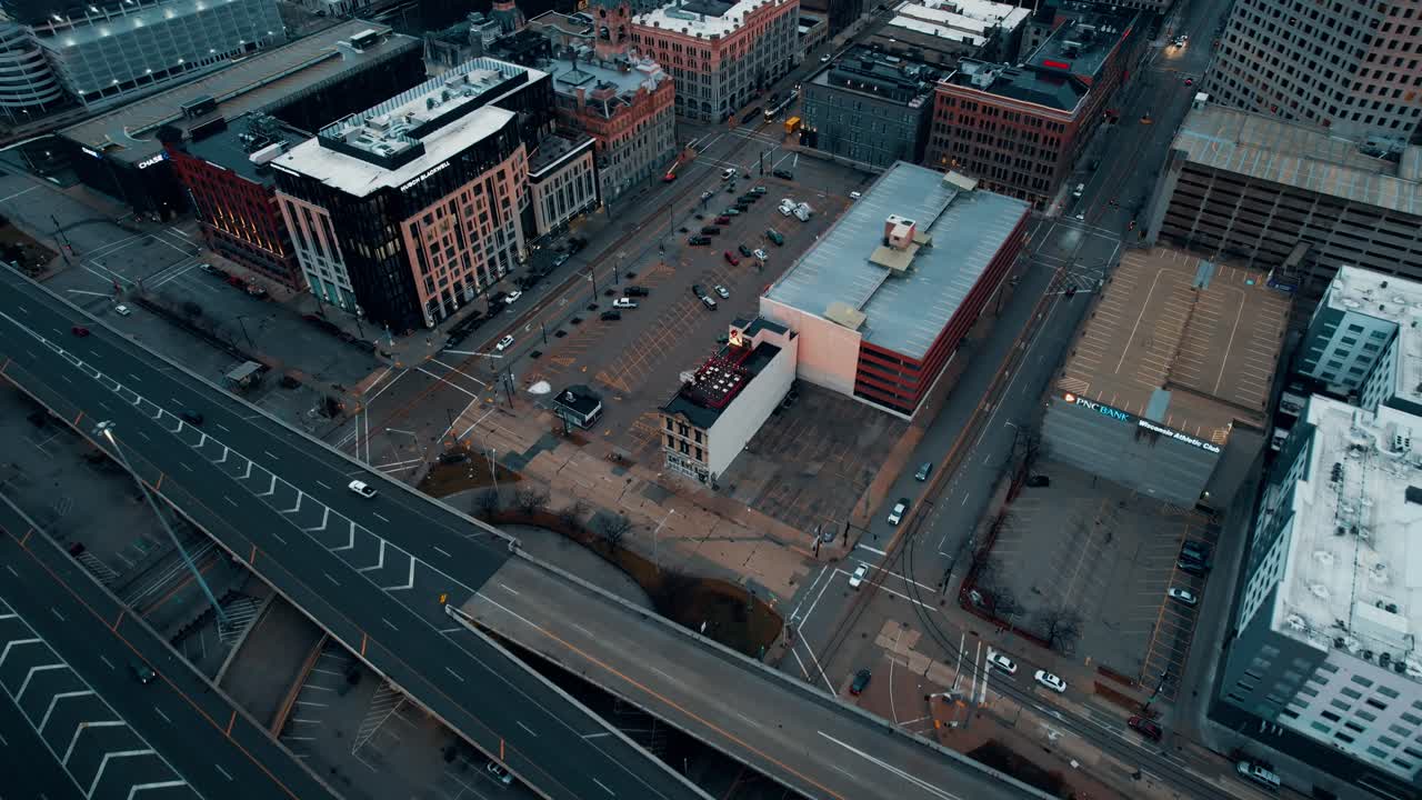 sunrise aerial of milwaukee, wisconsin downtown, above Interstate 794 towards Mitchell building with a cinematic color grade