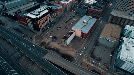 sunrise aerial of milwaukee, wisconsin downtown, above interstate 794 towards mitchell building with a cinematic color grade