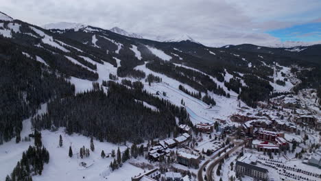 parking lot base half pipe big air jump ski snowboard gondola ski lift aerial drone cinematic copper mountain base colorado winter december christmas ski runs trails landscape forward reveal