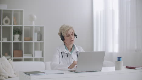 online appointment with dietologist middle-aged woman is consulting people remotely by internet from her office in clinic