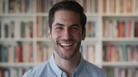 portrait-attractive-young-man-laughing-cheerful-enjoying-successful-lifestyle-happy-independent-male-in-bookshelf-background