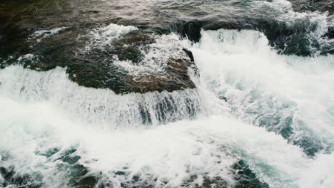 View-from-above-of-the-stream-of-a-clear-mountain-river.-120-fps-slow-motion-video