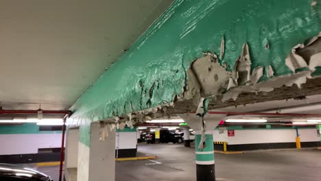 Paint-peeling-inside-underground-parking-garage-in-urban-city-center-building-development