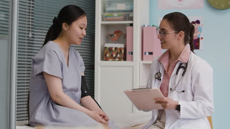 doctor examining patient in clinic