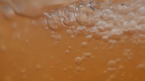 Refresco-Carbonatado-De-Naranja-Con-Gas-Llenando-Un-Vaso,-Macro-Primer-Plano