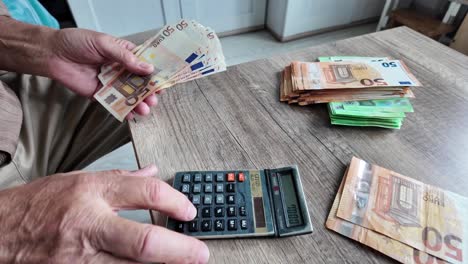 pensioner man counts life savings on a calculator