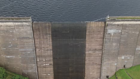 Booth-wood-reservoir-aerial-view-looking-down-over-concrete-barrier-holding-flowing-West-Yorkshire-lake