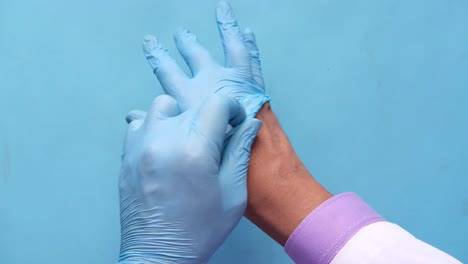 putting on medical gloves