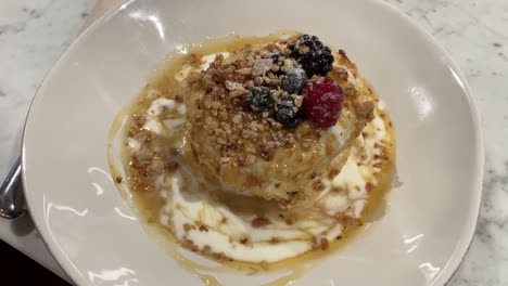 Homemade-american-pancakes-with-fresh-blueberry,-raspberries-and-honey