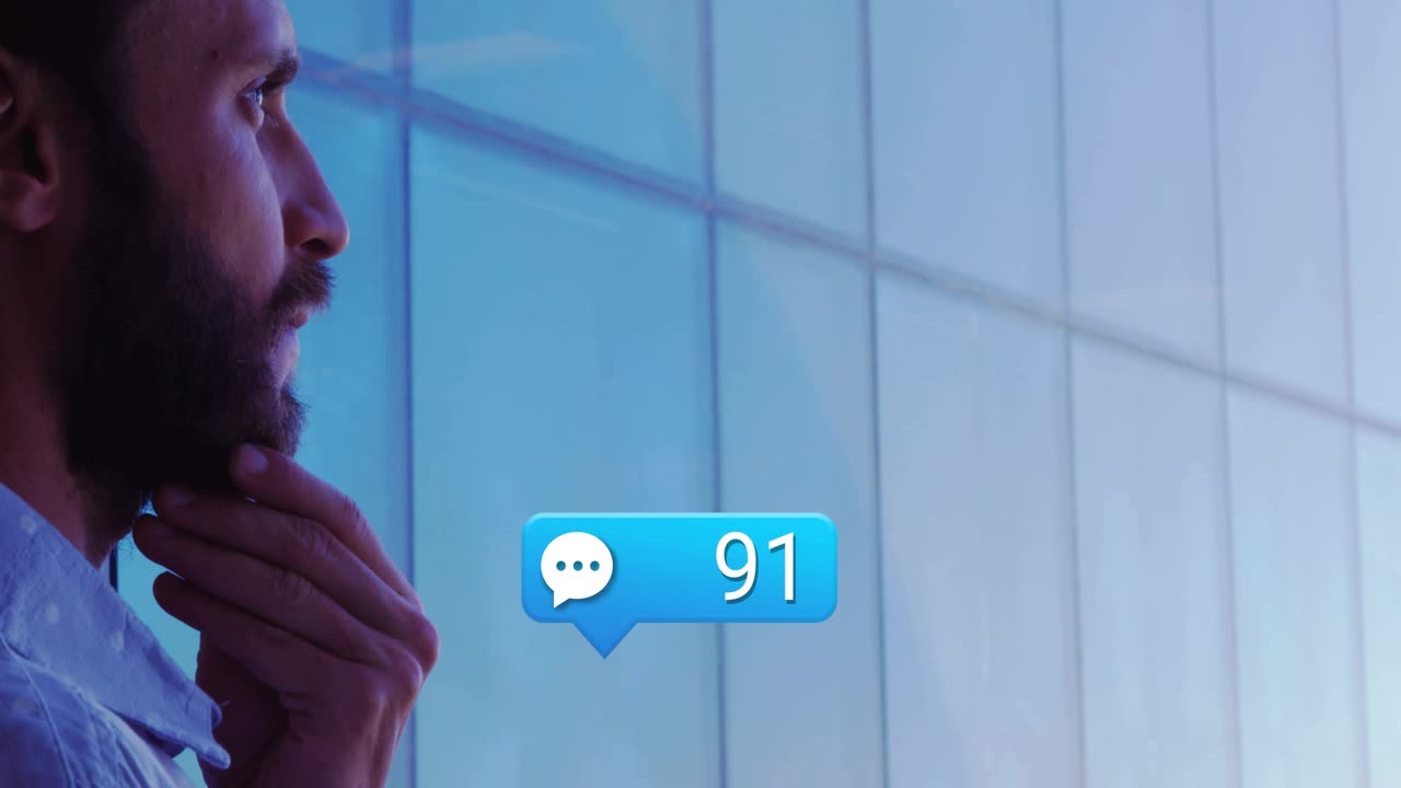 Businessman tapping smartphone by glass wall, causing chat counts rising and monitoring messages