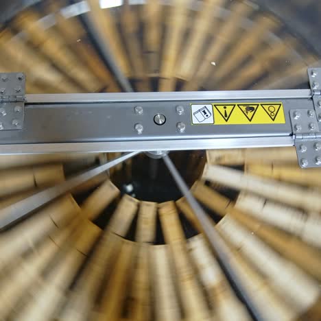 honey extractor. centrifuge with frames spinning inside and pumping honey. industrial equipment to extract fresh honey from honeycombs. top view