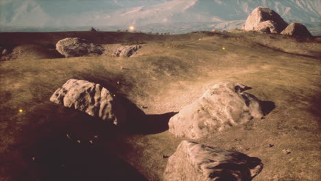 peaceful grassy landscape with rocks and a mountain in the distance