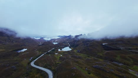 FPV-Drone-flying-through-the-foggy-high-altitude-Andes-mountain-peaks-in-the-Cajas-National-Park,-Cuenca,-Ecuador