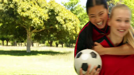 Female-football-teammates-celebrating-a-win-in-the-park