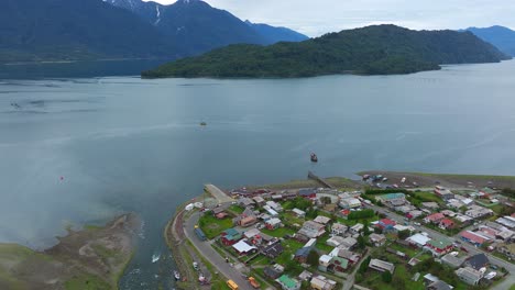 aerial flying over hualaihué, a chilean commune located in palena province, los lagos region beside fjord waterway