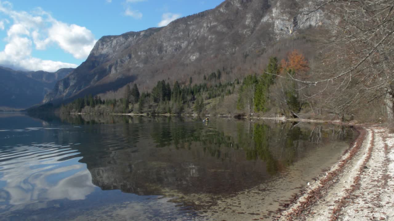 A canoe passing by on a mountain lake