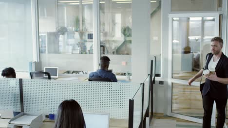 office worker bringing coffee to colleague in morning