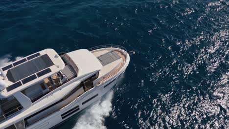 Luxury-yacht-driving-over-beautiful-blue-waters-at-sea-in-slow-motion-filmed-by-drone