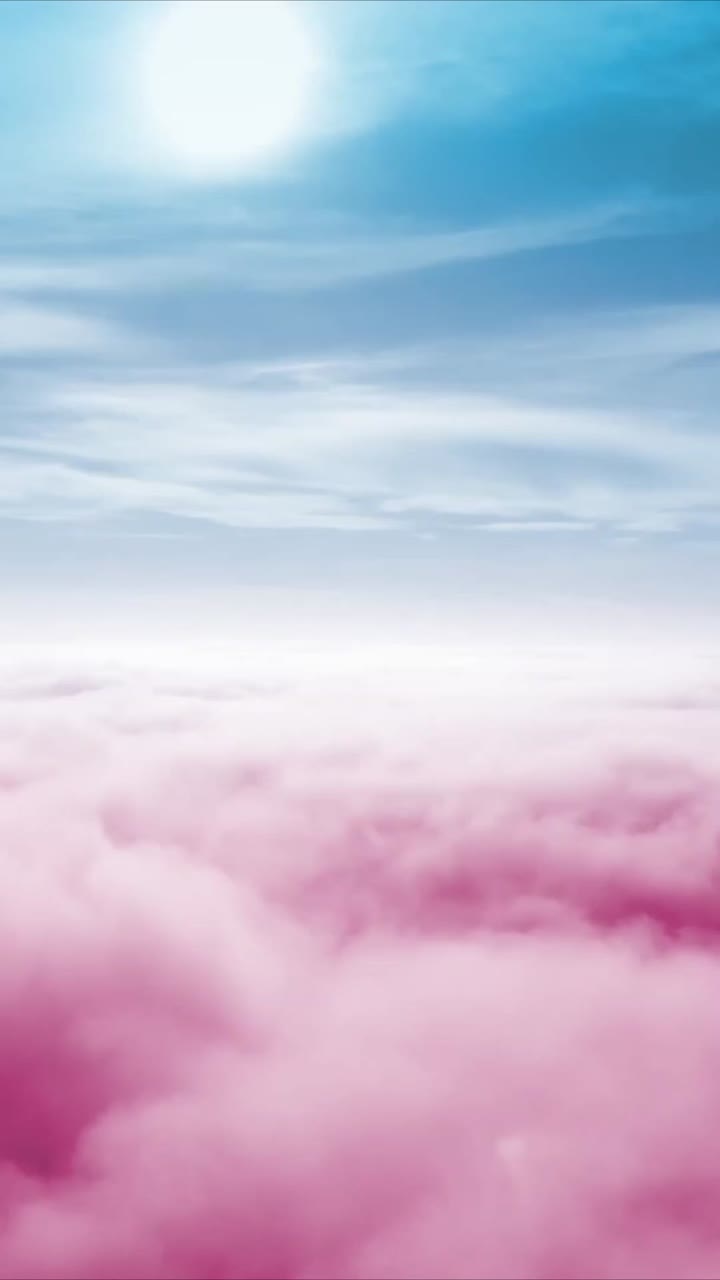 Dreamy Pink Clouds Floating Under a Blue Sky with Sun