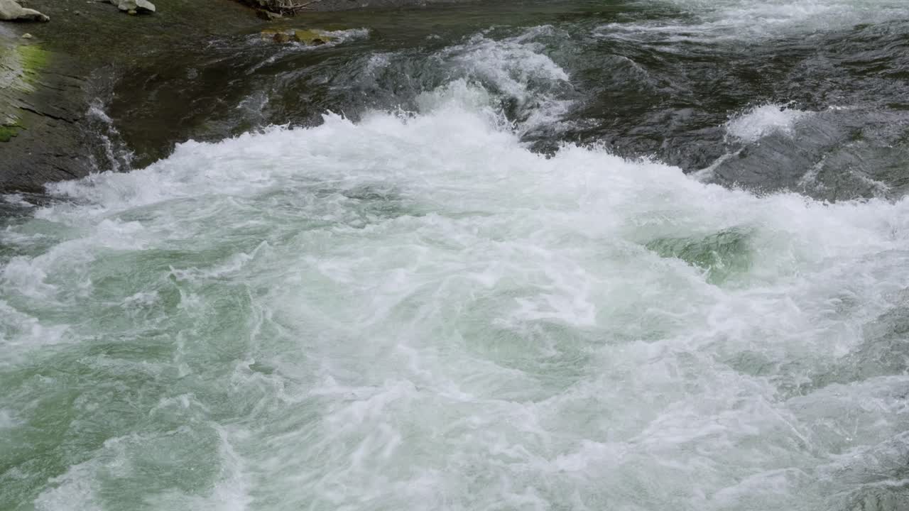Cinematic view over mighty river crashing in slow motion
