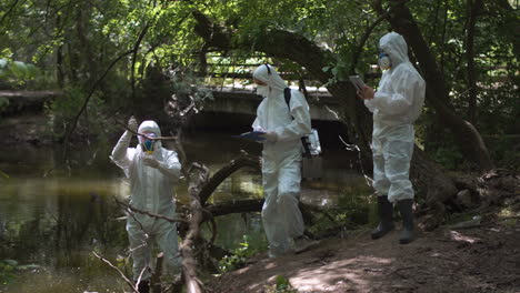 environmental scientists monitoring water quality in a forest