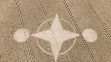 curious crop circle in middle of dry brown farm land, preston candover