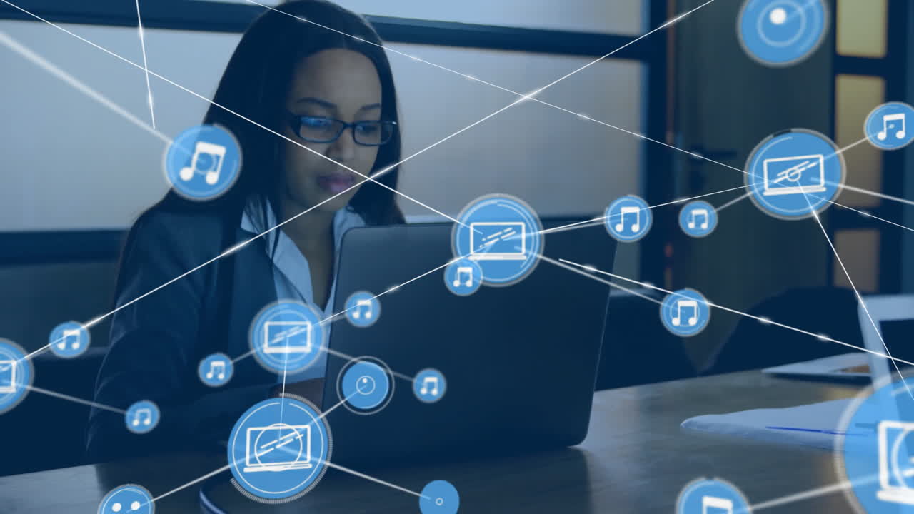 animación de una red de conexiones con iconos sobre una mujer de negocios biracial usando una computadora portátil