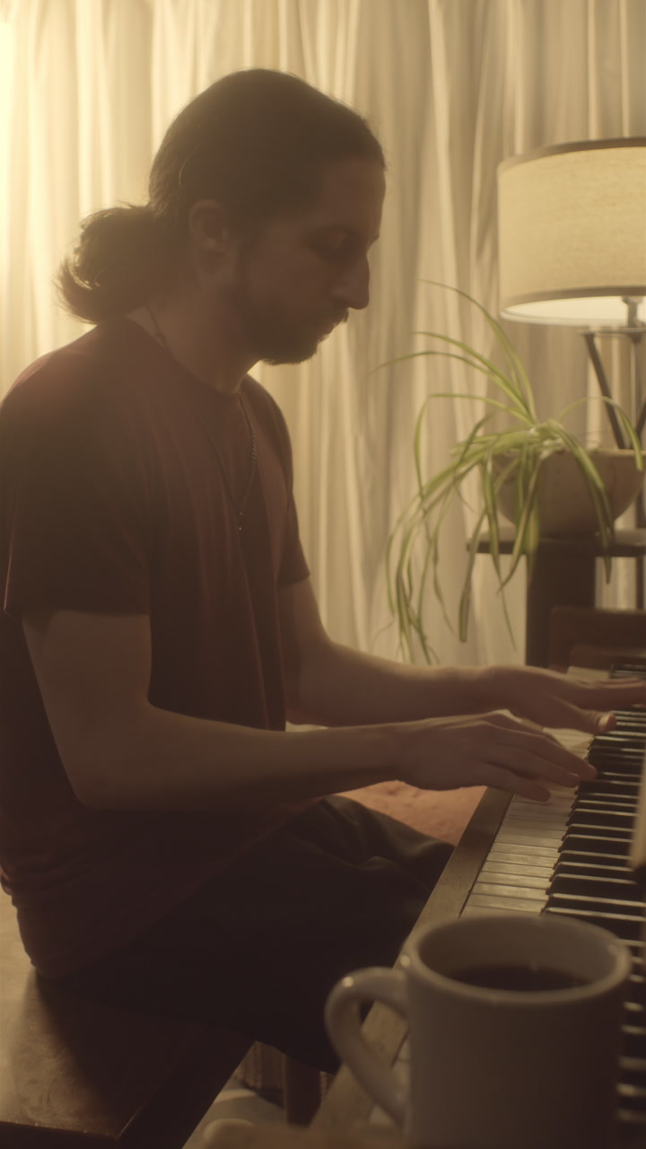 Pianist practicing at home in cozy interior during morning hours, vertical