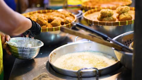 vendor deep frying bananas at floating market