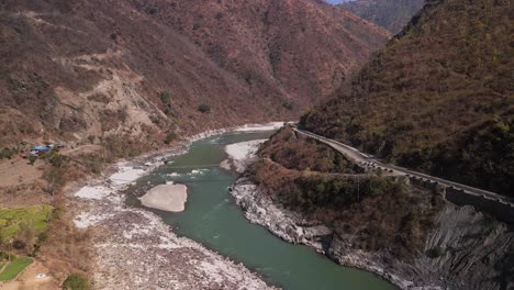 a serene river flowing through majestic mountain peaks: tranquil landscape with verdant valleys