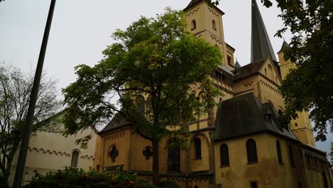 st mary in the capitol in germany in autumn, old beautiful riche with monastery between autumn trees