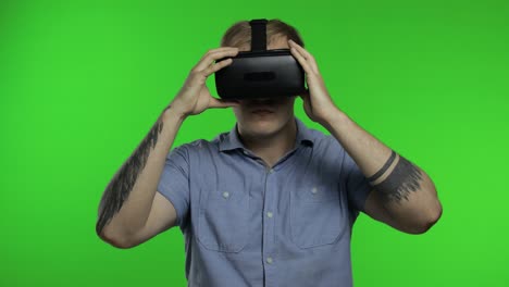 man using vr app helmet to play simulation game, drawing. guy watching virtual reality 3d video