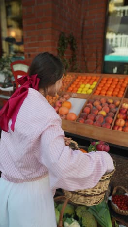 woman shopping for fruits and vegetables at a street market