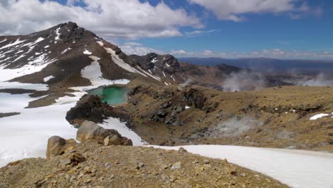 rocks, mountains and snow with clouds coming up and outstanding new zealand panoramic view