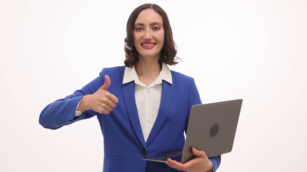 Female customer service agent with headset and laptop giving thumbs up
