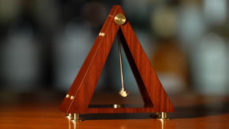 elegant wooden and brass triangular desk ornament