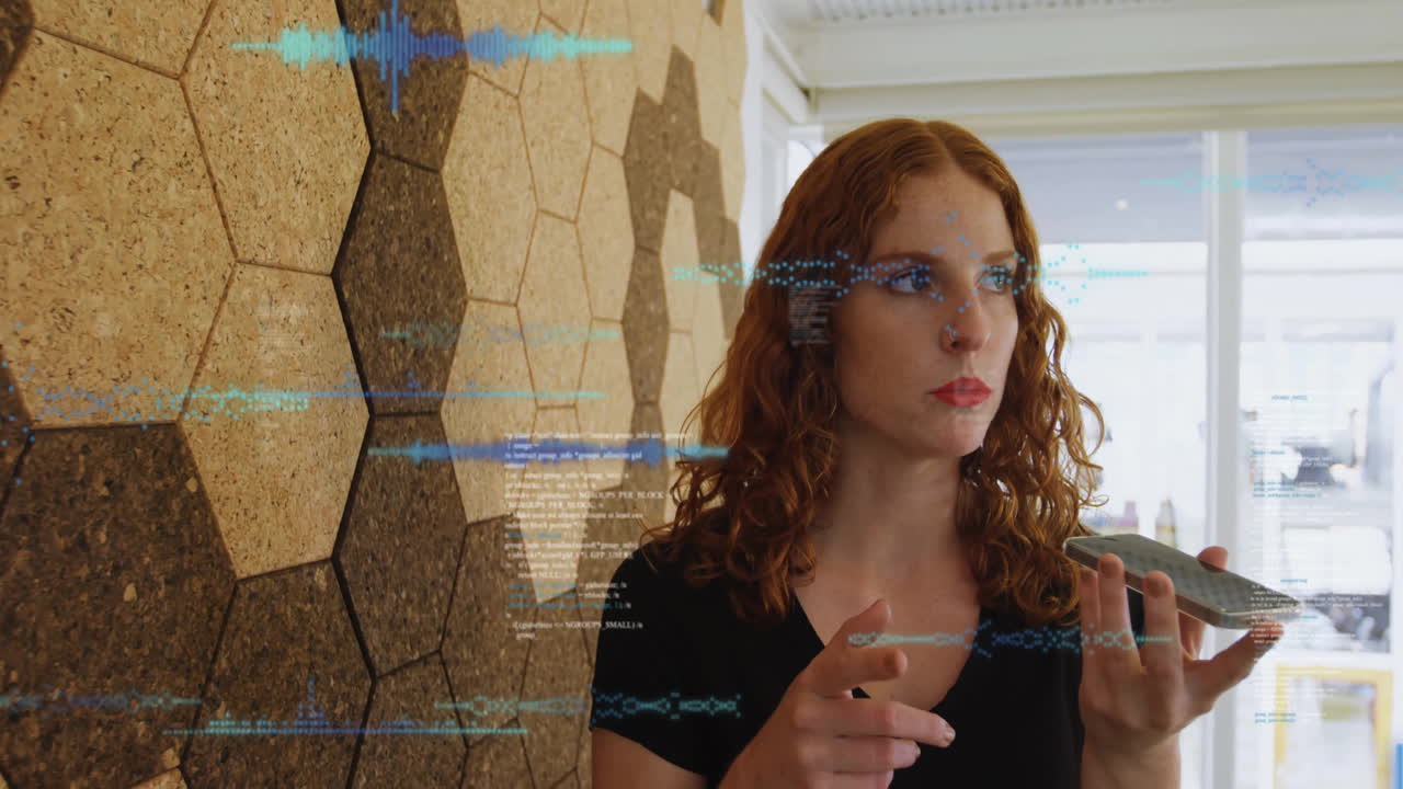 Interacting with futuristic digital animation, red-haired woman in modern office