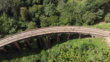 high up drone view of nine arch bridge tourist attraction in jungle in sri lanka